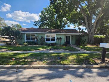 Charming single-story home featuring a well-manicured lawn and mature trees adding great curb appeal at 2830 W Bay Haven Dr, Tampa, FL 33611
