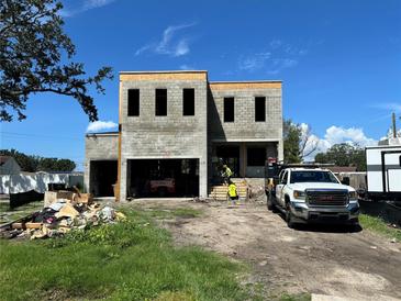 New construction home featuring block construction and a two-car garage in a residential neighborhood at 4321 S Renellie Dr, Tampa, FL 33611