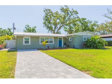 Charming single-story home with a well-manicured lawn and inviting blue front door at 4516 S Trask St, Tampa, FL 33611