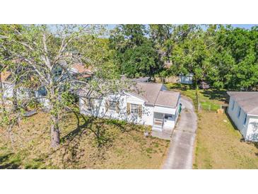 An aerial view of a charming single-story home featuring a well-maintained yard and mature trees at 1025 W Berry Ave, Tampa, FL 33603