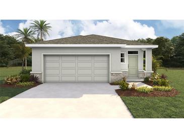 Charming single-story home featuring a two-car garage, neutral paint, and landscaping at 10583 Dusty Boot Rd, Land O Lakes, FL 34638