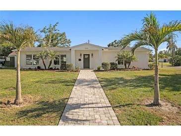 Charming single-story home with lush lawn, landscaped yard, and inviting pathway at 5298 Oxford N Ave, St Petersburg, FL 33710
