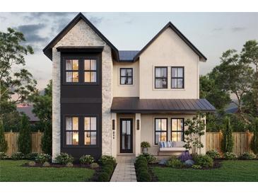 Charming two-story home featuring a stone facade, black framed windows and professionally landscaped front yard at 211 29Th Ave N, St Petersburg, FL 33704