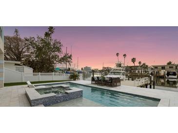 Inviting pool with spa and boat dock, perfect for waterfront relaxation and yacht enthusiasts at 326 129Th E Ave, Madeira Beach, FL 33708