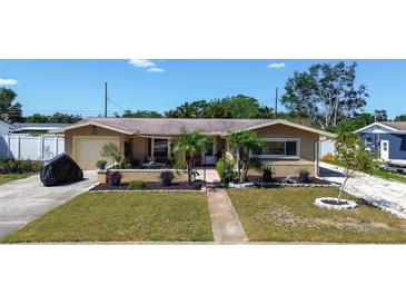 Inviting home with mature landscaping, green lawn, and charming curb appeal at 5931 33 N Ave, St Petersburg, FL 33710