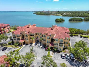 Mediterranean-style condos feature red tile roofs, lush landscaping, and convenient parking near the bay at 2739 Via Capri # 1024, Clearwater, FL 33764