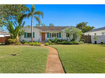 Charming home featuring a well-manicured lawn, mature palms, and a welcoming walkway to the front door at 432 39Th Ne Ave, St Petersburg, FL 33703
