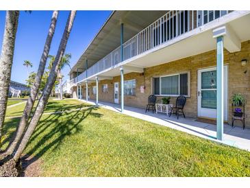 Inviting condo exterior featuring a well-kept lawn and neutral color scheme at 5247 81St N St # 4, St Petersburg, FL 33709