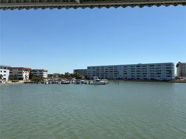 Scenic waterfront view of the condo complex, featuring a marina, beautiful buildings and calm water at 5940 30Th S Ave # 206, Gulfport, FL 33707