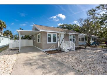 Charming single-story home with a carport, well-maintained lawn, and a welcoming front porch at 122 10Th Ave, Indian Rocks Beach, FL 33785
