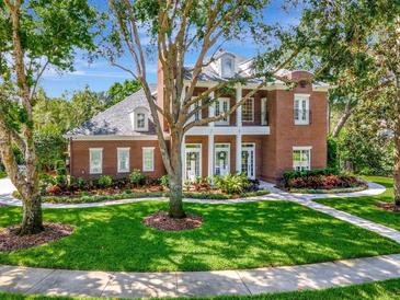 Beautiful brick home with a manicured lawn and a symmetrical design at 29540 Chapel Park Dr, Wesley Chapel, FL 33543