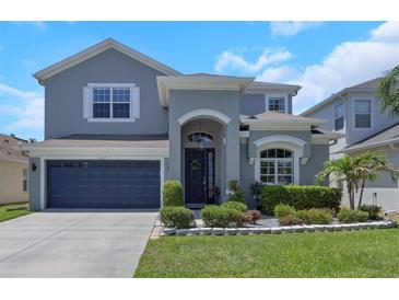 Charming two-story home with a well-manicured lawn, beautiful landscaping and an attached two-car garage at 10007 Coldwater Loop, Land O Lakes, FL 34638