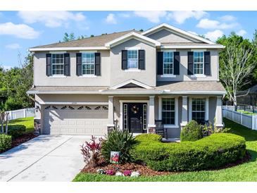 Charming two-story home features a well-maintained yard, neutral paint, and a two car garage at 27549 Stonecreek Way, Wesley Chapel, FL 33544