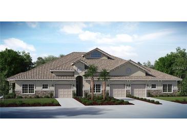 Inviting townhome exterior featuring a tile roof, neutral stucco, and well manicured tropical landscaping in the front at 29823 Ganga Way, Wesley Chapel, FL 33543