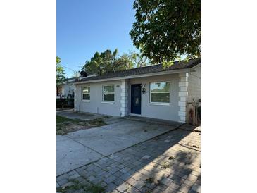 Charming single-story home featuring a well-maintained exterior and inviting front entrance at 9618 N 13Th St, Tampa, FL 33612