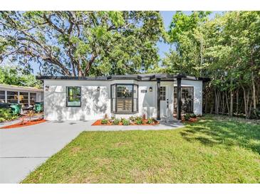 Charming single story home features a well manicured lawn, fresh landscaping, and neutral exterior at 120 12Th N Ave, Safety Harbor, FL 34695