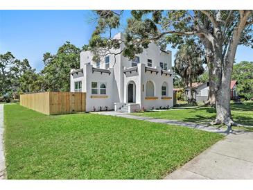 Stunning two-story home boasting a lush green lawn, new wood fence, and mature trees at 3000 19Th S Ave, St Petersburg, FL 33712