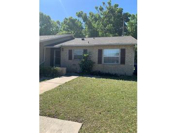Charming single-story brick home with well-maintained lawn and classic architectural details at 9501 Lake Park Dr # 9501, Thonotosassa, FL 33592