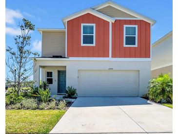 Charming two-story home with attached two-car garage, landscaped front yard and colorful exterior at 12908 Hawkstone Trail Blvd, Lithia, FL 33547