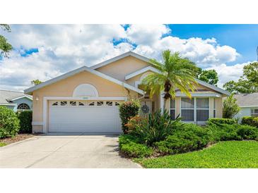 Charming single Gathering home featuring a 2-car garage and well-manicured landscaping with tropical plants at 4909 Linsey Ct # 0, Sarasota, FL 34243