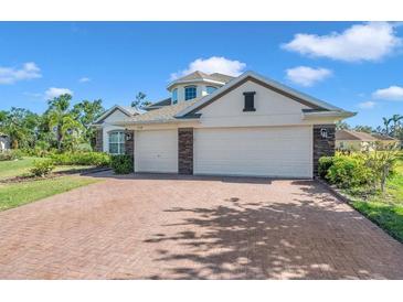 Charming home with a brick driveway, three-car garage, and well-maintained landscaping at 5518 72Nd E Ter, Ellenton, FL 34222