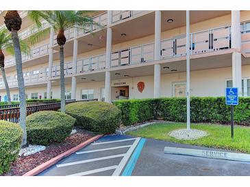Low angle of the condo building's manicured landscaping and handicap parking space at 5623 80Th N St # 306, St Petersburg, FL 33709