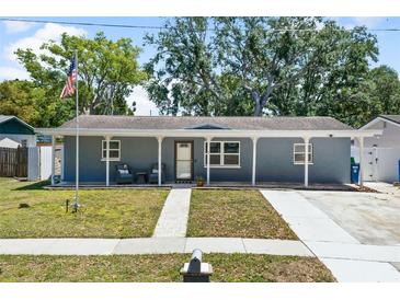 Charming one-story home featuring a lovely front porch and well-maintained landscaping, creating inviting curb appeal at 9653 Golden Grove St, Seminole, FL 33772