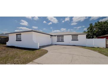 Exterior view of the single-story home showcasing its painted concrete and garage at 1204 Croydonwood Cir, Brandon, FL 33510