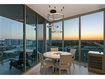 Dining room with luxury chandelier has floor to ceiling windows that offer city views at 777 3Rd N Ave # 1408, St Petersburg, FL 33701