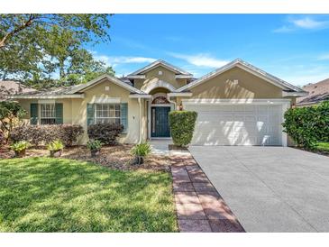 Charming single Gathering home with a two-car garage and well-maintained landscaping at 1518 Rolling Meadow Dr, Valrico, FL 33594