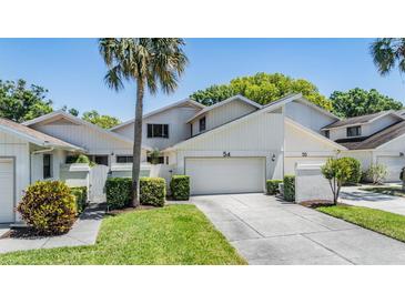 Well-maintained two-story home with a two-car garage and lush landscaping at 486 Lakeview Dr # 54, Palm Harbor, FL 34683
