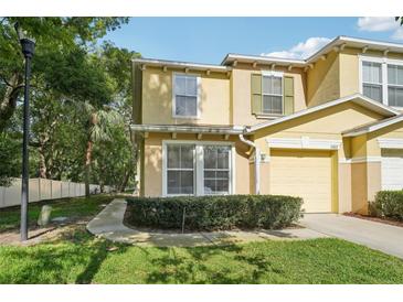 Charming two-story townhome with landscaped front yard and attached one car garage at 5302 Aloha Seed Dr, Seffner, FL 33584