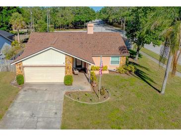 Charming single Gathering home with a well maintained front yard and a driveway leading to a one car garage at 10833 96Th N St, Largo, FL 33773
