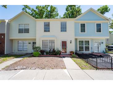 Charming townhome with a well-maintained exterior, neat landscaping, and inviting front porch at 1728 Mill Run Cir, Tampa, FL 33613