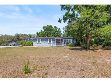 Charming single-story home featuring a cozy front porch, well-shaded by mature trees and natural landscaping at 2805 Olavet Ct, Valrico, FL 33596