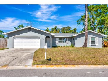 Charming single-story home featuring a well-maintained lawn and an attached garage, perfect for suburban living at 3044 Golden Rain Dr, Sarasota, FL 34232