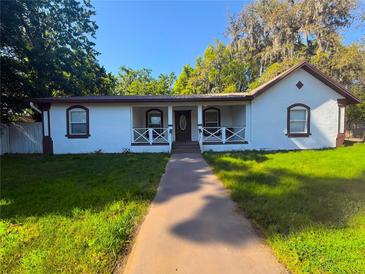 Charming home with a covered front porch and manicured front lawn at 40709 Melrose Ave, Zephyrhills, FL 33540