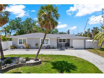 Charming single-story home with a well-manicured front yard and a large palm tree at 7800 Causeway N Blvd, St Petersburg, FL 33707