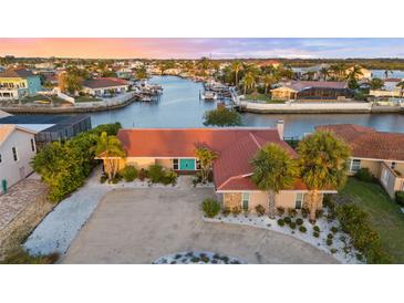 Beautiful waterfront home with lush landscaping, private dock, and stunning sunset views at 4968 Southshore Dr, New Port Richey, FL 34652