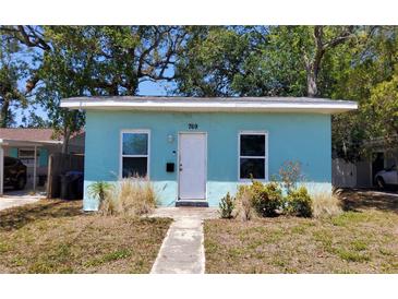 Charming single-story home with a light blue exterior, front yard, and a walkway leading to the front door at 769 53Rd N Ter, St Petersburg, FL 33703