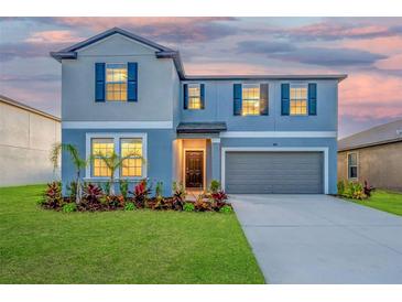 Charming two-story home featuring well-maintained landscaping and a two-car garage at 9893 Branching Ship Trce, Wesley Chapel, FL 33545