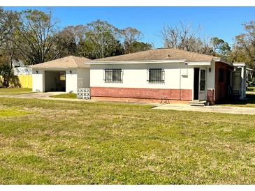 Charming single-story home with a separate garage and well-maintained lawn at 318 Banana St, Tarpon Springs, FL 34689