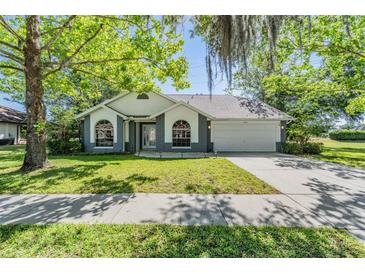 Charming single-story home featuring a manicured lawn and a two-car garage at 6302 Silver Oaks Dr, Zephyrhills, FL 33542