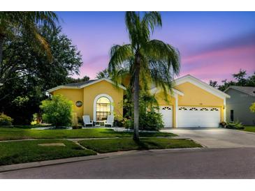 Beautiful home with a well-kept yard, two-car garage, and welcoming front seating area, perfect for relaxing at 11209 Pocket Brook Dr, Tampa, FL 33635