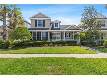 Charming two-story home featuring well-manicured landscaping, a covered porch, and a welcoming facade at 20113 Bending Creek Pl, Tampa, FL 33647