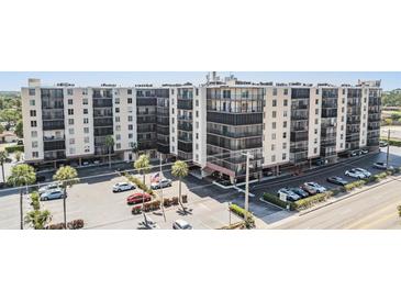 Multi-story condo building with on-site parking and mature trees on a sunny day at 2901 26Th W St # 317, Bradenton, FL 34205