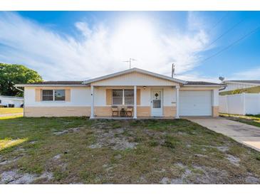Cozy single-Gathering home with a well-lit front porch, single car garage, and mature tree providing shade at 3706 Cambridge St, New Port Richey, FL 34652