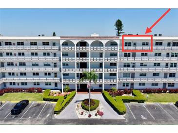 Well-maintained condo complex featuring lush landscaping, mature palm trees, and ample parking at 5501 80Th N St # 509, St Petersburg, FL 33709
