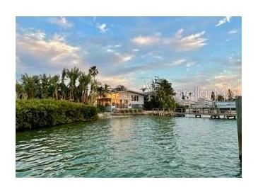 Waterfront home with lush landscaping and private dock in a tranquil setting at 712 Sunset Cv, Madeira Beach, FL 33708