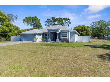 Charming single-story home featuring a well-maintained lawn and a light blue exterior at 8604 Vicksburg Rd, Spring Hill, FL 34608